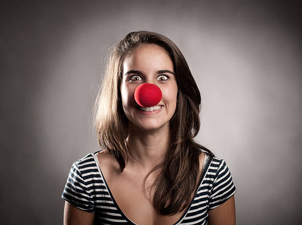 istock young girl with a clown nose 187558828
