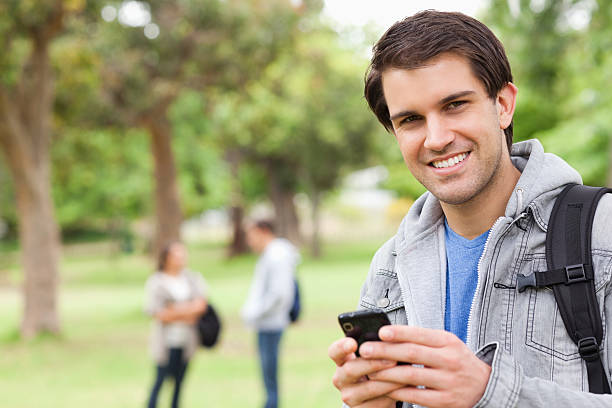 istock Portrait of a male student using his smartphone 187559677