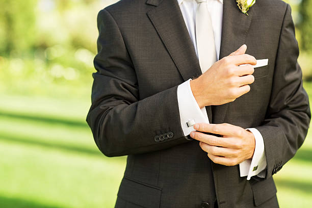 istock Groom Adjusting Hand Cuff In Garden 187559706