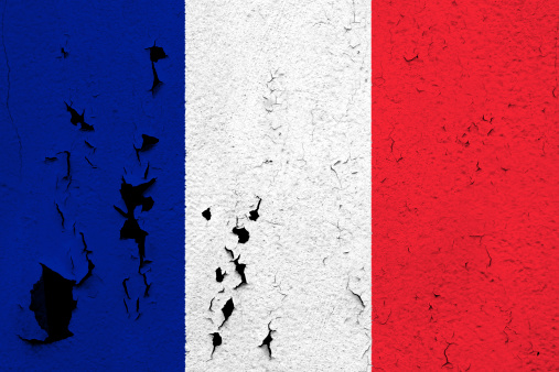 The flag of France painted on a cracked and peeling wall.