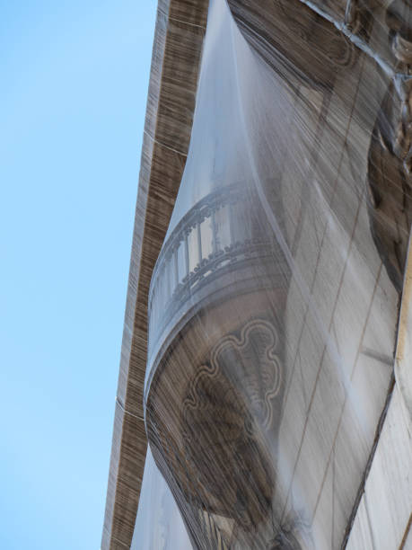 istock Dilapidated balconies with nets on an old building in Barcelona 1875617541