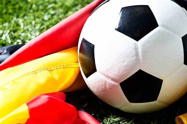 istock Soccer ball on grass with German national flag 187561858