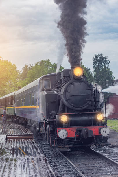 istock Retro steam train approaches to the platform. 1875619070
