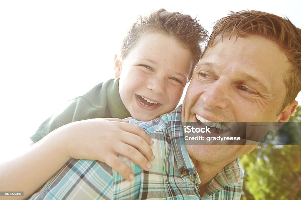 I love you dad! A happy little boy being carried by his father on a sunny day 40-49 Years Stock Photo