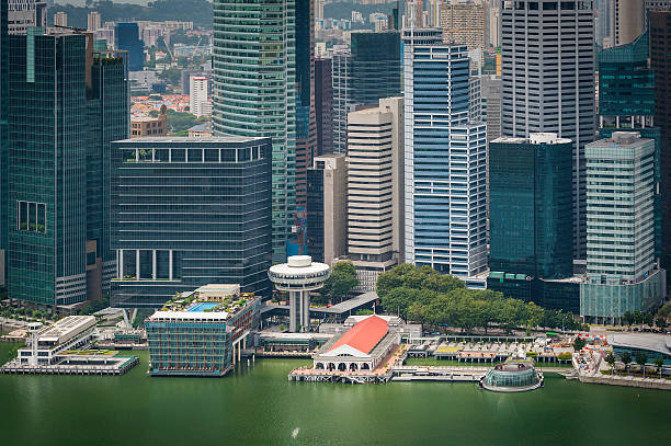 The crowded skyscraper cityscape of Singapore's Central Business District towering over the hotels and restaurants of Marina Bay. ProPhoto RGB profile for maximum color fidelity and gamut.