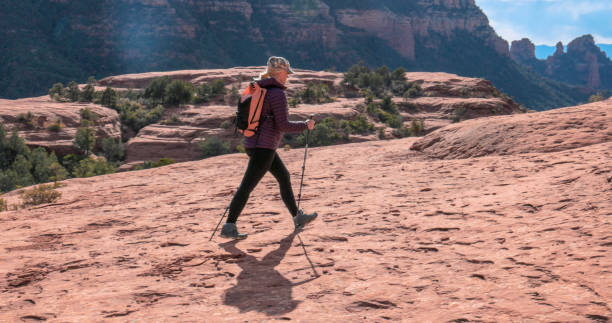 istock Mature woman hikes through desert landscape 1875654184