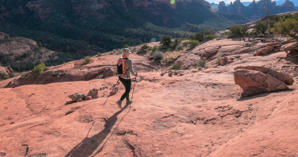istock Mature woman hikes through desert landscape 1875654709