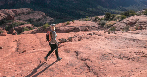istock Mature woman hikes through desert landscape 1875654710
