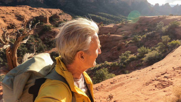 istock Mature man hikes through desert landscape 1875657311