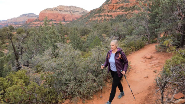 istock Mature woman hikes through desert landscape 1875659370