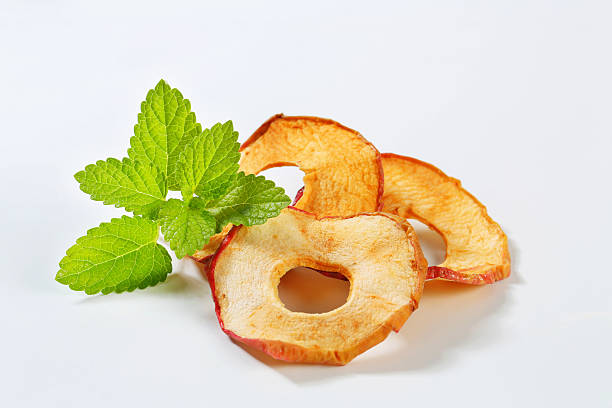 Slices of dried apple on white background
