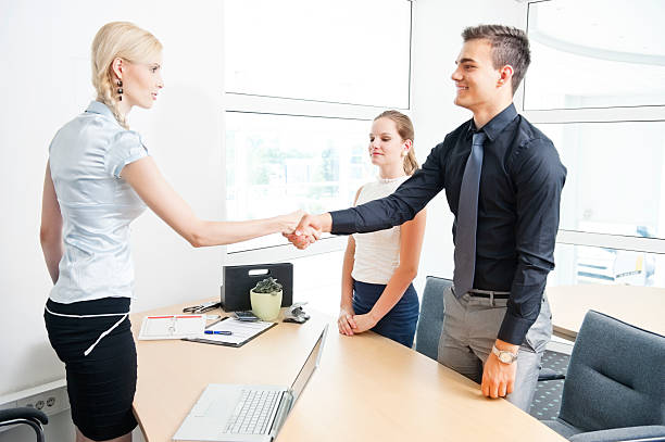istock Young Couple and Counselor Handshaking 187567100