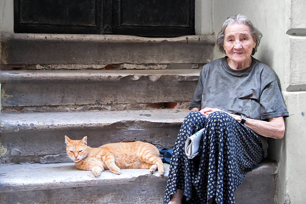 Poverty Old woman in poverty sitting on street beggar stock pictures, royalty-free photos & images