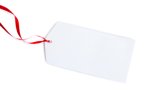 A blank gift tag tied with red ribbon on a white background