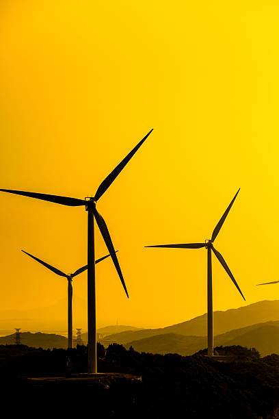 istock wind turbine and electrical towers on sunset 187567699