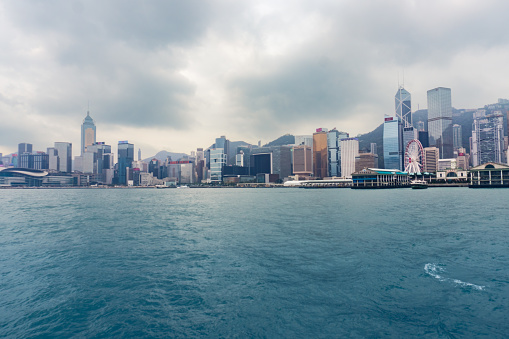 Hong Kong,March 27, 2019:View of the Hong Kong skyscrapers from the ferrie crossing the Victoria Harbour during a cloudy day