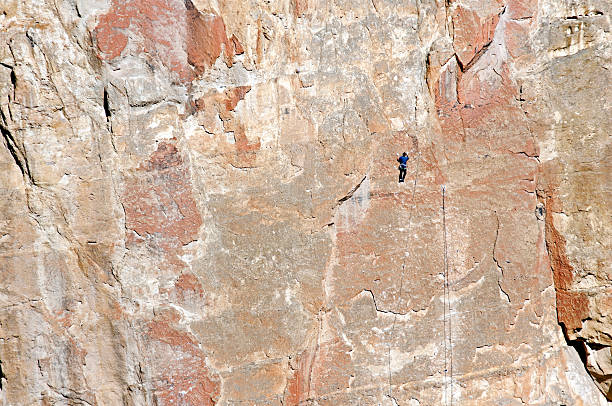 istock Rock climber scaling cliff in central Oregon 187568980