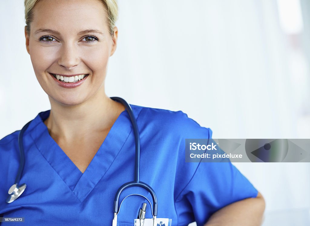 Someone you can trust Smiling female doctor wearing scrubs and a stethoscope 20-29 Years Stock Photo