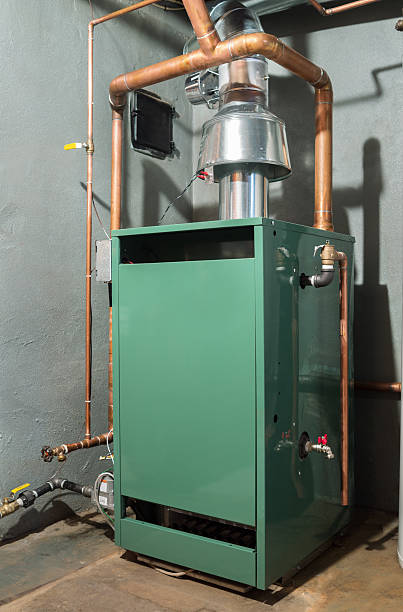 New home heating system New Steam heat furnace fueled with natural gas. furnace stock pictures, royalty-free photos & images