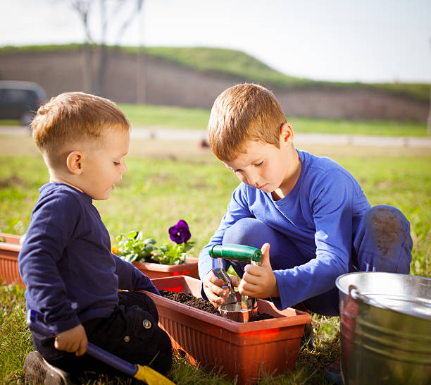 istock Family planting flowers 187571020