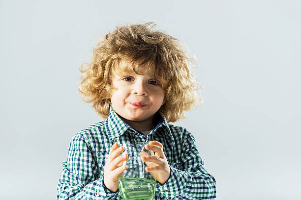 istock Boy holding a glass of water. 187571029