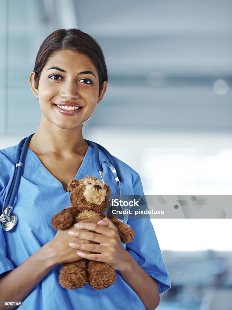 She's a caring pediatrician Portrait of a smiling ethnic doctor holding a teddy bear with copyspace Doctor Stock Photo