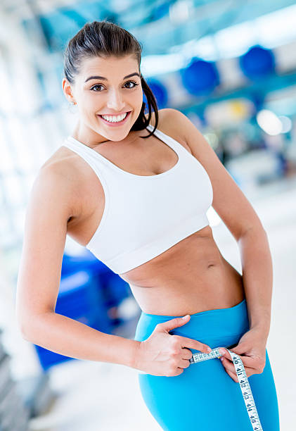 istock Happy woman measuring her hips 187571286