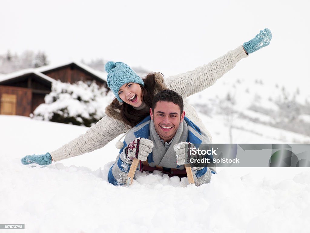 Young Couple In The Snow Young couple get playful in the snowYoung couple get playful in the snow Adult Stock Photo