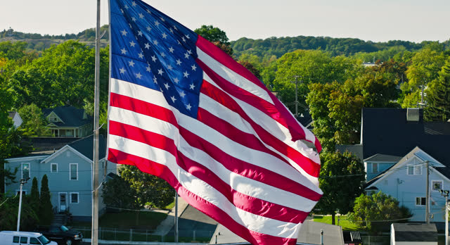 Rightward Orbiting Aerial of American Flag in Grand Haven, Michigan