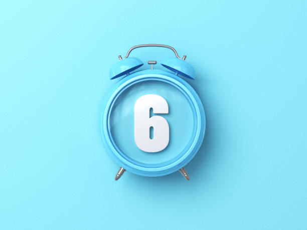 istock Number Six Sitting Over Blue Alarm Clock On Blue Background 1875741537