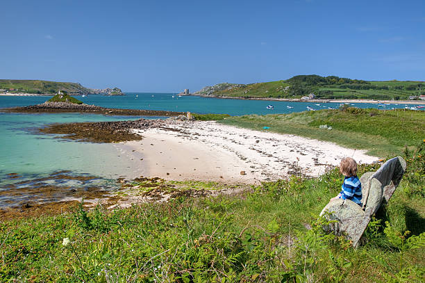 Boy on holiday, Cornwall Boy looking towards Plumb Island, Tresco, Isles of Scilly, Cornwall, England. isles of scilly stock pictures, royalty-free photos & images