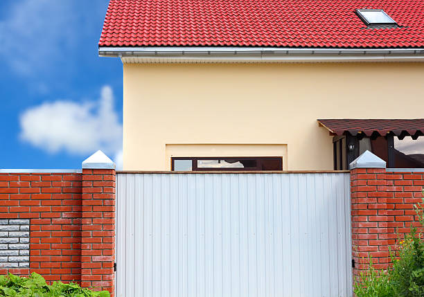 istock House behind the fence 187575999
