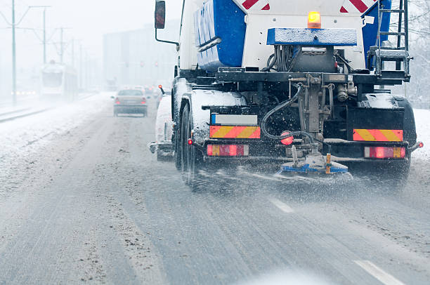 istock working snowblower on the street at winter time 187576233
