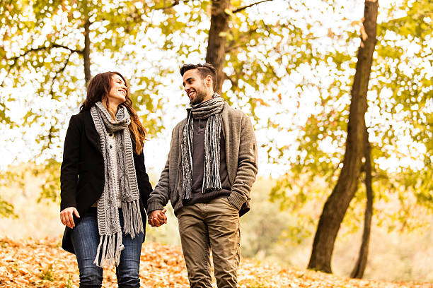 istock Smiling couple walking in the park 187577667