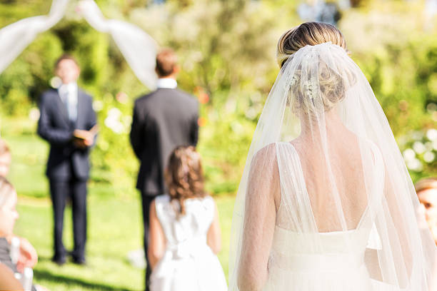 istock Bride Wearing Veil Walking Down The Aisle During Outdoor Wedding 187579214