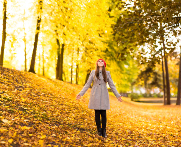 istock Young Woman Looking Up Holding Maple Leaf 187579231