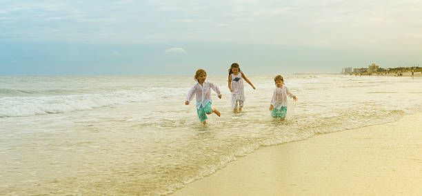 istock Kids Running In Ocean 187579747