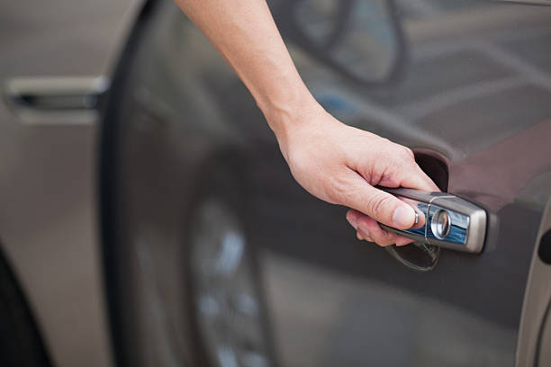 istock Hand opening car door 187580179