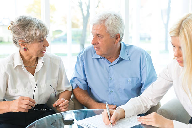 istock Elderly couple purchasing life insurance 187580834