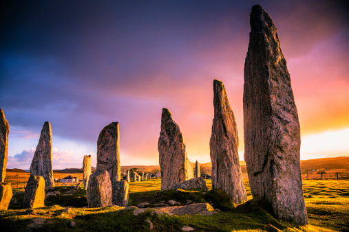 The ancient standing stones of Callanish (or Calanais) on Lewis in the Outer Hebrides of Scotland at sunrise. Built about 5000 years ago, the deeply textured stones of Callanish are arranged in allignments of avenues and a central circle not unlike a celtic cross.