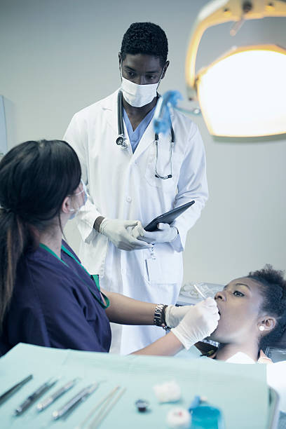 istock Dentist hygienist checking for cavities 187581881