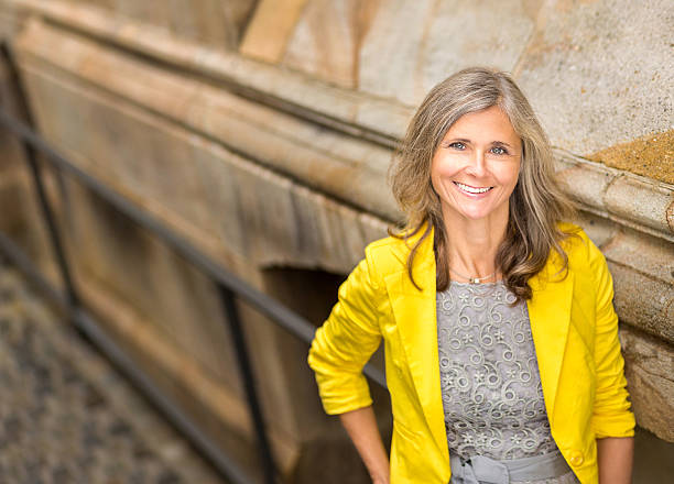 istock Smiling Woman Leaning Against Wall 187582028