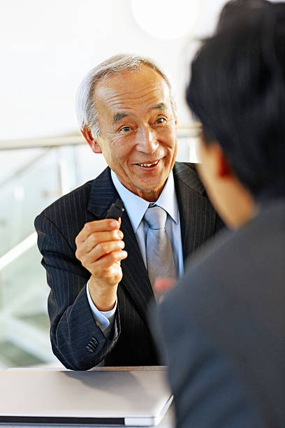 istock Senior businessman sharing data with coworker 187582899