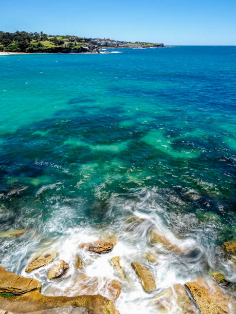 istock Powerful white waves (blurred motion) crashing into rocky coastline 1875833185