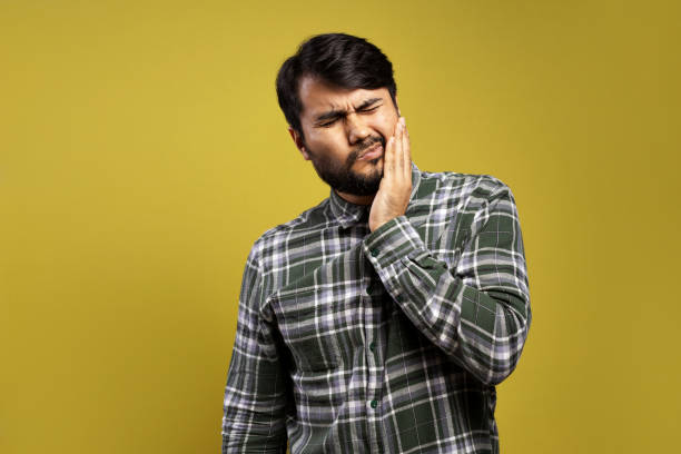 istock man feeling pain in his tooth and with his hand on his face 1875855294