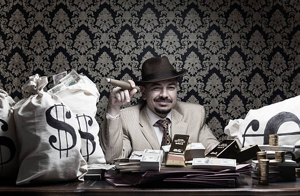 istock Rich man posing with money bags and dollar bills 187591071