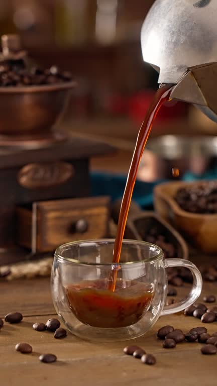 Man hand pouring coffee from a geyser coffee maker