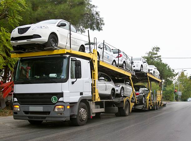 vehicles being transported by a truck