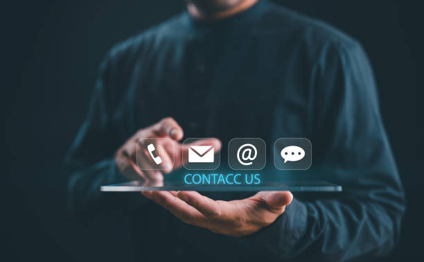 istock Contact us or Customer support hotline, people connect. Businessman show on virtual screen contact icons email, address, live chat, telephone. Customer service, helpdesk advice online support 1875945912