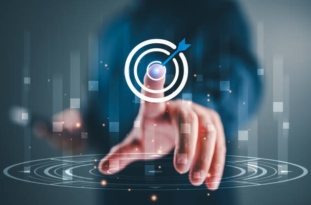 istock Businessman touch on arrow dart to virtual target dart board. Setup objectives and target for business investment concept, Digital marketing, Business goal and technology concept. 1875947053
